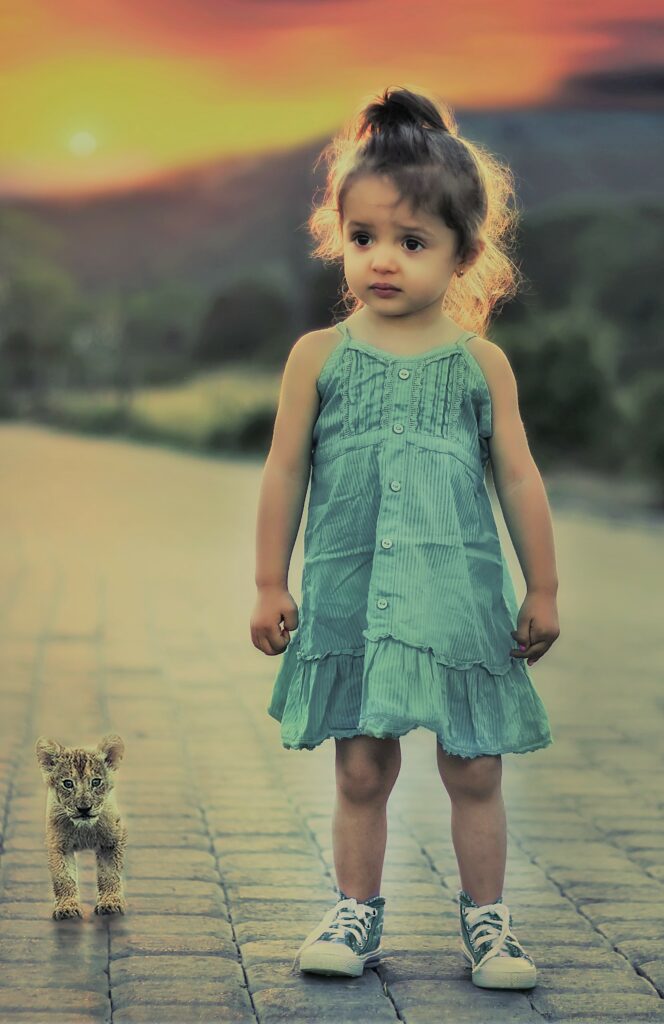 little girl with tiny wild cat