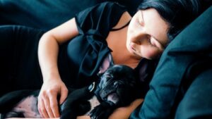 woman cuddling dog